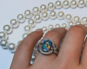 black opal ring with pearl jewellery in the background
